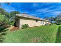 Tan house exterior with well-maintained lawn at 601 Lakescene Dr, Venice, FL 34293