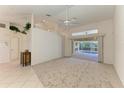 Spacious living room with high ceilings and sliding glass doors to the pool at 601 Lakescene Dr, Venice, FL 34293