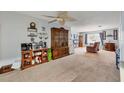 Spacious living room with a large cabinet and ceiling fan at 6045 Slade Rd, North Port, FL 34287