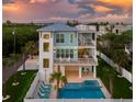 Elevated view of a two-story teal home with a pool and deck at 630 Companion Way, Longboat Key, FL 34228