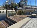 Private boat lift with wooden dock and paver walkway at 633 Avenida De Mayo, Sarasota, FL 34242