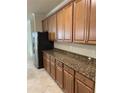 Kitchen with wood cabinets and granite countertops at 6442 Willowshire Way, Bradenton, FL 34212