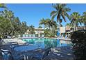 Community pool with plenty of lounge chairs at 7092 W Country Club N Dr, Sarasota, FL 34243