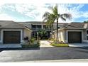 Front view of condo building with landscaping and garages at 9621 Castle Point Dr # 1024, Sarasota, FL 34238