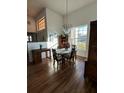 Bright dining room with hardwood floors, chandelier, and a view to the entryway at 1144 Hoover St, Nokomis, FL 34275