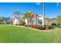 Exterior view of the house with lush landscaping at 1144 Hoover St, Nokomis, FL 34275