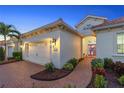 Elegant exterior featuring a two-car garage and a welcoming entryway at 11816 Altamonte Ct, Venice, FL 34293