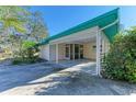 Covered carport with adjacent screened porch at 1220 De Narvaez Ave, Bradenton, FL 34209