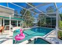 Inviting pool and spa with a screened enclosure and patio furniture at 1220 De Narvaez Ave, Bradenton, FL 34209