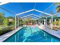 Refreshing screened pool and spa with lounge chairs at 1220 De Narvaez Ave, Bradenton, FL 34209