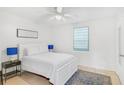 Bright bedroom with a white bed frame, blue lamps, and a patterned rug at 1335 12Th St, Sarasota, FL 34236