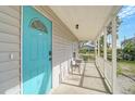 Inviting front porch with a small table and chairs, perfect for relaxing at 1335 12Th St, Sarasota, FL 34236