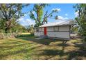 Charming house with a red door and spacious grassy yard at 1717 32Nd St, Sarasota, FL 34234