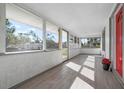 Bright and airy front porch with tile floors and screened enclosure at 1717 32Nd St, Sarasota, FL 34234