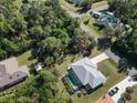 House with pool and backyard, surrounded by lush green trees at 18314 Koala Ave, Port Charlotte, FL 33948