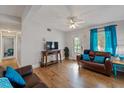 Living room with brown leather couches, wood floors, and a TV at 207 Waterway Ne Cir, Port Charlotte, FL 33952