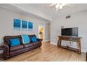 Living room with brown leather couches, wood floors, and a TV at 207 Waterway Ne Cir, Port Charlotte, FL 33952