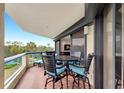 Relaxing balcony with outdoor furniture and lovely garden views at 2110 Harbourside Dr # 526, Longboat Key, FL 34228