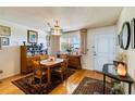 Bright dining area with hardwood floors, featuring a wood table and chairs at 255 The Esplanade N # 506, Venice, FL 34285