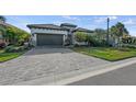 Single-story home with paver driveway and landscaping at 328 Aria Dr, Nokomis, FL 34275