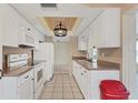 Clean kitchen featuring white cabinets and modern appliances at 3608 Joyce Dr, Bradenton, FL 34208