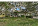 Single-story home with a two-car garage nestled in a tree-lined setting at 4655 Pine Green Trl # 24, Sarasota, FL 34241