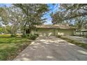 House exterior showcasing a light-green two-car garage and manicured lawn at 4655 Pine Green Trl # 24, Sarasota, FL 34241