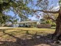 House exterior showcasing a large tree and fenced backyard at 4819 Greenleaf Rd, Sarasota, FL 34233