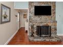 Stone fireplace with a TV above in the living room at 4819 Greenleaf Rd, Sarasota, FL 34233