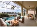 Relaxing pool and patio area with wicker furniture, overlooking a lake at 5154 51St W Ln, Bradenton, FL 34210