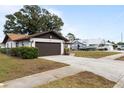 House exterior showcasing a brown garage door and side yard at 5506 3Rd Avenue W Plz, Bradenton, FL 34209