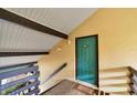 Condo building entryway with teal door and steps at 5671 Ashton Lake Dr # 3, Sarasota, FL 34231