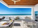 Spacious balcony with ocean views, a seating area, and dining space perfect for enjoying coastal living at 6100 Midnight Pass Rd # 401, Sarasota, FL 34242