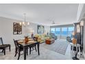 Bright living room with ocean views, comfortable seating, and dining area at 6140 Midnight Pass Rd # 902, Sarasota, FL 34242