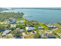 Stunning aerial view of waterfront property, showcasing the home and neighborhood at 7820 Holiday Dr, Sarasota, FL 34231