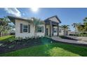 Modern home exterior with a metal roof, landscaping and walkway at 7820 Holiday Dr, Sarasota, FL 34231