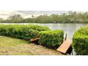 Wooden dock on calm river at 7820 Midnight Pass Rd, Sarasota, FL 34242