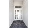 Bright entryway with modern door and tile flooring at 7917 Mainsail Ln, Sarasota, FL 34240