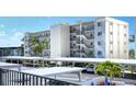 Condo building with parking and tropical landscaping at 797 Beach Rd # 305, Sarasota, FL 34242