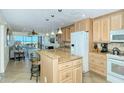 Well-equipped kitchen with granite island and modern cabinetry at 797 Beach Rd # 305, Sarasota, FL 34242