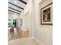 Elegant hallway with hardwood floors and recessed lighting leading to the living areas at 8253 Grande Shores Dr, Sarasota, FL 34240