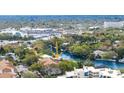 Aerial view of the house highlighting its location by the water and a sprawling neighborhood at 850 S Tamiami Trl # 408, Sarasota, FL 34236