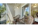 Relaxing screened patio furnished with wicker chairs and a glass table at 850 S Tamiami Trl # 408, Sarasota, FL 34236