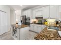 Spacious kitchen with granite countertops and stainless steel appliances at 9109 Winter Harbour Way, Bradenton, FL 34212