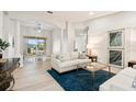 Bright living room with light-colored sofa, coffee table, and hardwood floors at 9109 Winter Harbour Way, Bradenton, FL 34212