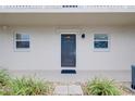 Condo entrance with dark gray door and landscaping at 972 La Costa Cir # 5, Sarasota, FL 34237