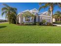 Landscaped yard with palm trees and a house with garage at 12426 Tranquility Park Ter, Bradenton, FL 34211