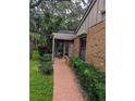 Pathway to covered entryway, surrounded by lush landscaping at 1507 Water Oak Way S, Bradenton, FL 34209