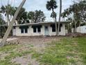 Quaint ranch home nestled amongst palm trees at 175 Island Cir, Sarasota, FL 34242