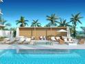 Resort-style pool with lounge chairs and cabanas at 223 Golden Gate Point # 2A, Sarasota, FL 34236